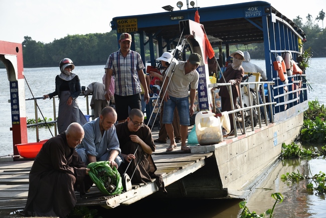 Praying for rebirth and releasing creatures in Ba Lua port, Cu Chi